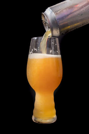 Serving beer from a can into an IPA beer glassの写真素材
