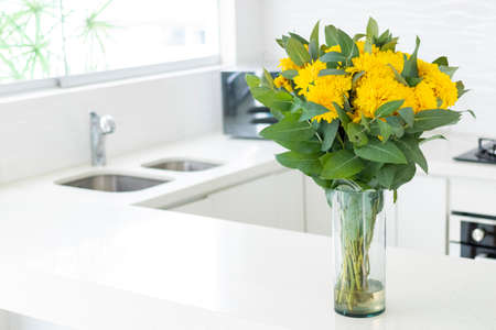 Cute flower arrangement in a home kitchenの写真素材