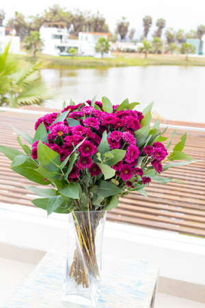 Flowers arrangement on table outdoors on the terrace of the houseの写真素材