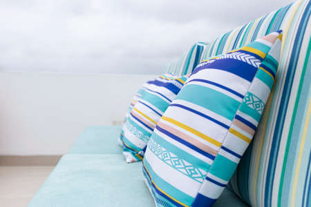 A relaxing spot for a warm, summer day with cute ecological sofa of various colors outdoorsの写真素材