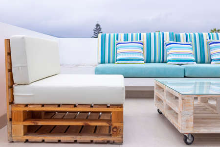 A relaxing spot for a warm, summer day with cute ecological sofa of various colors outdoorsの写真素材