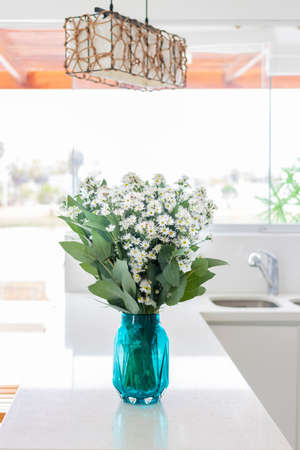 Cute flower arrangement in a home kitchenの写真素材