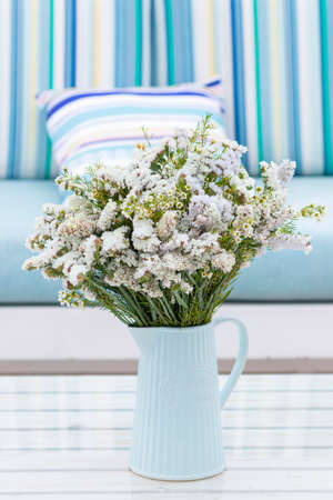 Flowers arrangement on table outdoors on the terrace of the houseの写真素材