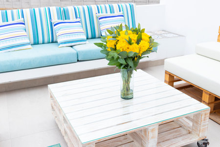 Flowers arrangement on table outdoors on the terrace of the houseの写真素材