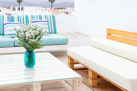 Flowers arrangement on table outdoors on the terrace of the houseの写真素材