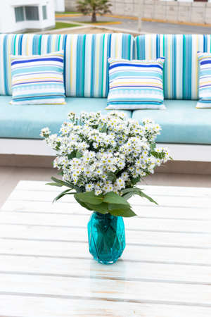 Flowers arrangement on table outdoors on the terrace of the houseの写真素材