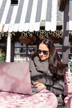 Pretty woman working with her laptop outdoorsの写真素材