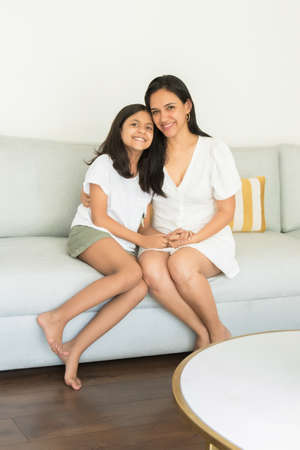 Cute mothers and daughter showing affection to each otherの写真素材
