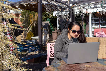 Pretty woman working with her laptop outdoorsの写真素材