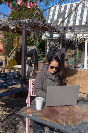 Pretty woman working with her laptop outdoorsの写真素材