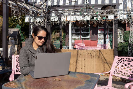 Pretty woman working with her laptop outdoorsの写真素材