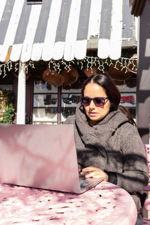 Pretty woman working with her laptop outdoorsの写真素材