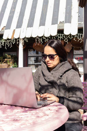 Pretty woman working with her laptop outdoorsの写真素材