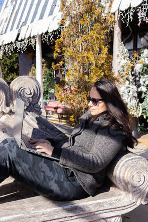 Pretty woman working with her laptop outdoorsの写真素材