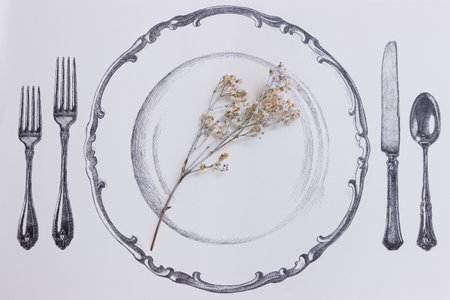 Utensils and plate decorated with a decorative branchの写真素材