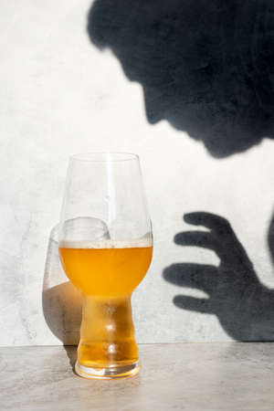 Head and hand shadow, trying to grab a glass of IPA beerの写真素材