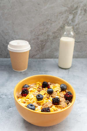 Breakfast with granola cereal and fruits, such as blueberry and blackberries