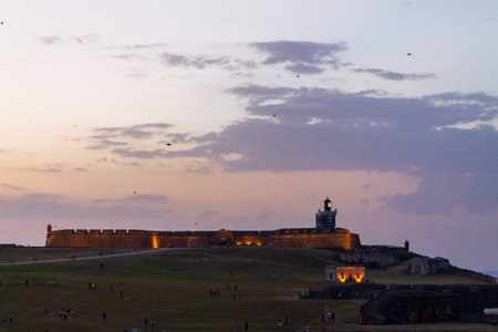 Old San Juan, Puerto Rico - Mar 22th 2014: People and children are flying kites at sunset, near the Morro de San Juan and the Santa MarÃ­a Magdalena de Pazzis Cemeteryのeditorial素材