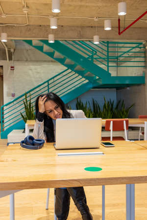 Brunette woman working from her workspace