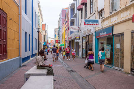 View of people in the colorful alleys of Willemstad in Curacaoのeditorial素材