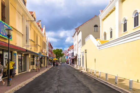 View of people in the colorful alleys of Willemstad in Curacaoのeditorial素材