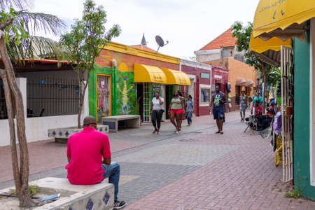 View of people in the colorful alleys of Willemstad in Curacaoのeditorial素材