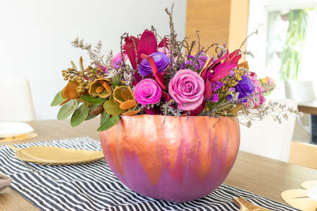 Floral arrangement of roses inside decorated pumpkinの写真素材
