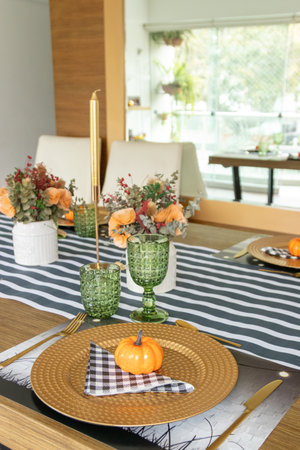 Table decorated for food on the occasion of Halloween, with flowers.の写真素材