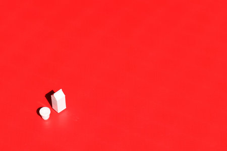 Milk container on red background. Conceptual