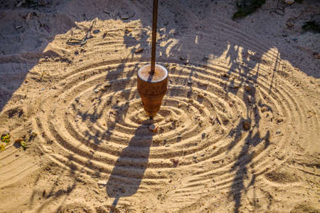Mathematical pendulum is drawing on the sand.の写真素材