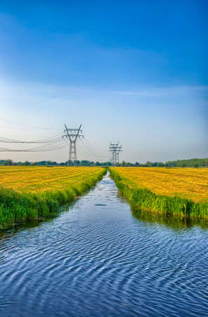 Dutch landscape with a canal and grass fields with mirror reflection in water, Amsterdam, Holland, Netherlands, HDRの写真素材