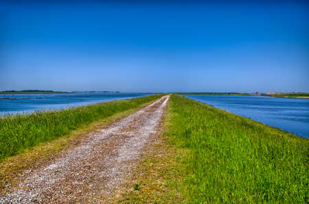 Country road surrounded by water, Holland, Netherlands, HDRの写真素材