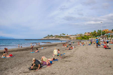 TENERIFE, SPAIN - DEC 2012: People sunbathing on the beach in resort Playa de Las Americas on December 6, 2012 in Tenerife, Spainのeditorial素材