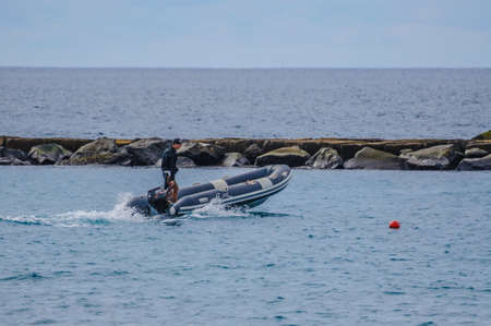 TENERIFE, SPAIN - DEC 2012: Man in rubber motorboat on December 6, 2012.のeditorial素材