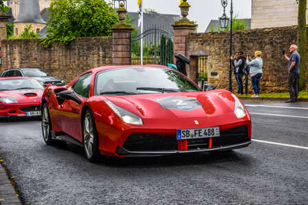 GERMANY, FULDA - JUL 2019: red FERRARI 488 coupe Type F142M is a mid-engine sports car produced by the Italian automobile manufacturer Ferrari. The car is an update to the 458 with notable exterior and performance changes. The car is powered by a 3.9-litrのeditorial素材