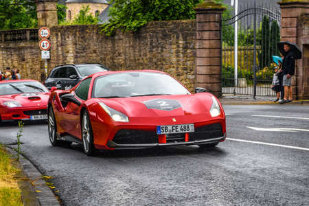 GERMANY, FULDA - JUL 2019: red FERRARI 488 coupe Type F142M is a mid-engine sports car produced by the Italian automobile manufacturer Ferrari. The car is an update to the 458 with notable exterior and performance changes. The car is powered by a 3.9-litrのeditorial素材