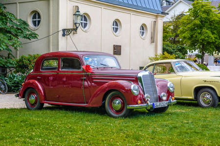 BADEN BADEN, GERMANY - JULY 2019: dark red MERCEDES-BENZ 220 limousine sedan W187, oldtimer meeting in Kurpark.のeditorial素材