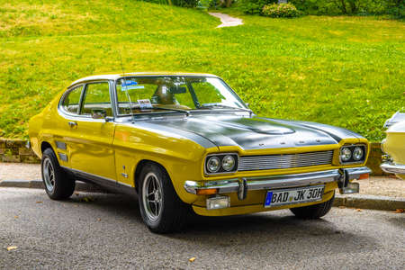 BADEN BADEN, GERMANY - JULY 2019: yellow black FORD CAPRI MK I 2800 1969 1974 sport coupe, oldtimer meeting in Kurpark.のeditorial素材