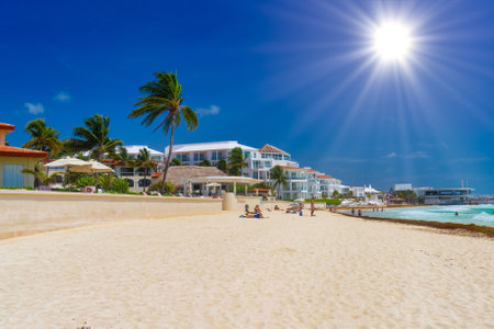 Sandy beach on a sunny day with hotels in Playa del Carmen, Mexico.の写真素材