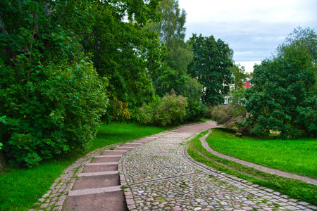Path in green meadow and trees in Park Mon Repos, Vyborg, Russia.の写真素材