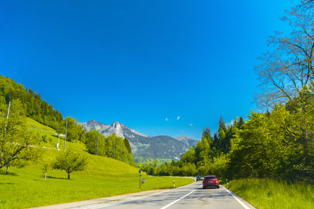 Cars on the road near the village Darstetten in Frutigen-Niedersimmental, Bern, Switzerland.の写真素材