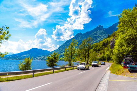 Road with cars near the lake with mountains, Alpnachstadt, Alpnach Obwalden Switzerland.の写真素材