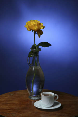 Yellow rose and a cup of teaの写真素材