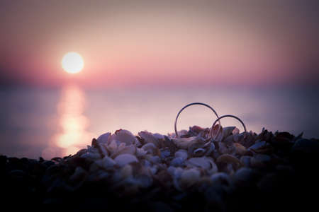 Picture of two wedding rings on seasideの写真素材