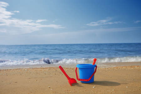 a photo of blue Bucket on beachの写真素材