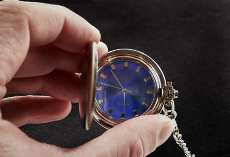 Vintage pocketwatch in close-up  shot held in hand.の写真素材