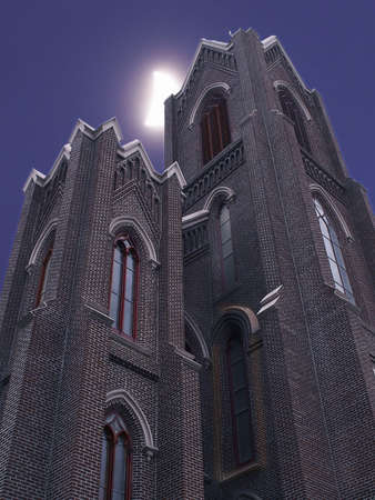 Crescent moon peaks from behind steeple tower of brick church.の写真素材