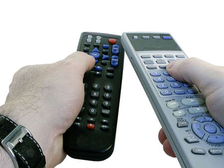 Two remote controls for TV/cable in man's hands -- isolated on white background.の写真素材