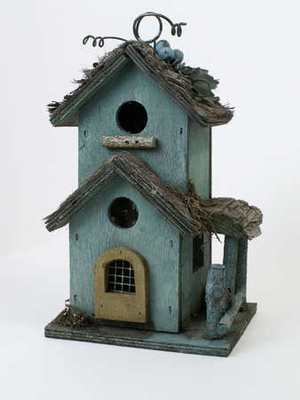 Weathered wooden birdhouse, isolated on white background.の写真素材