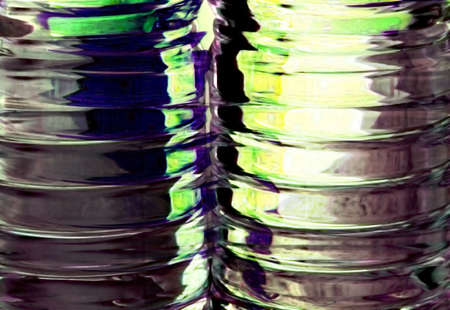 Abstract photo close-up of ribbed liquid containers with interesting green backlight.の写真素材